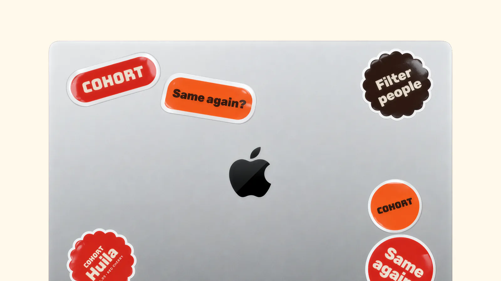 Laptop covered in Cohort stickers: wordmark, Same again?, Filter people and Huila