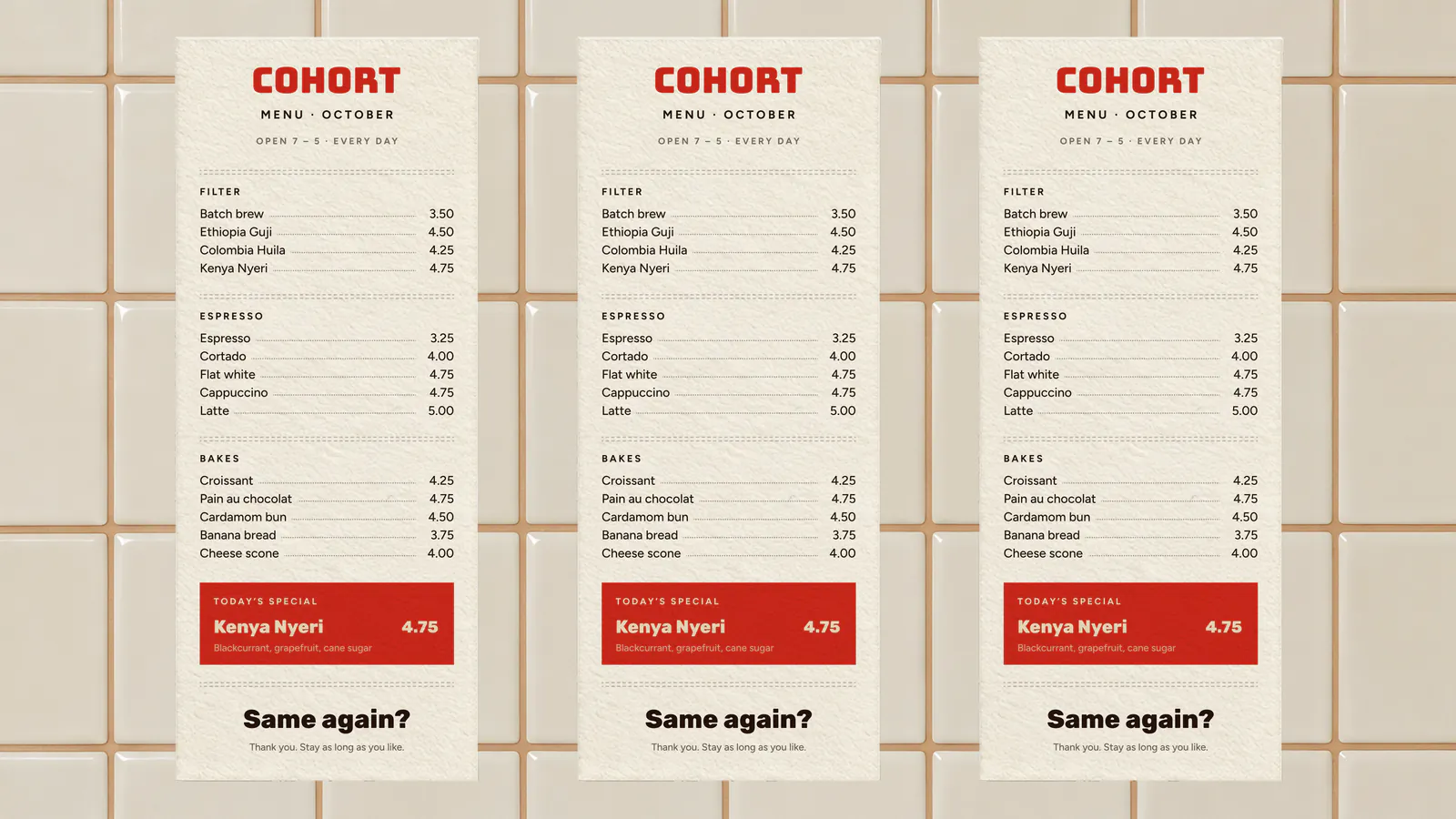 Three printed Cohort menus on a tiled wall