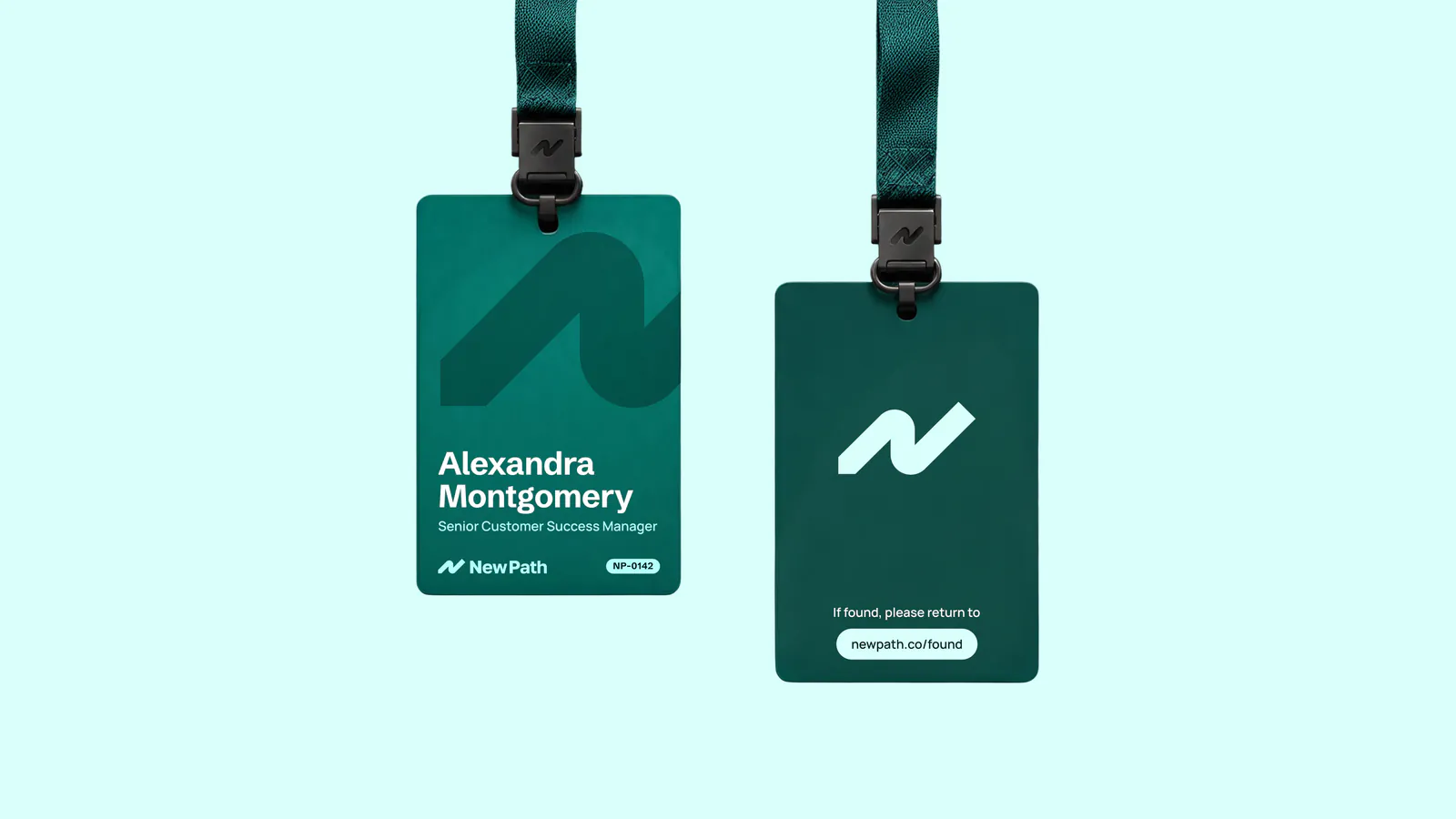 Staff lanyard badges in teal with the New Path mark, on mint