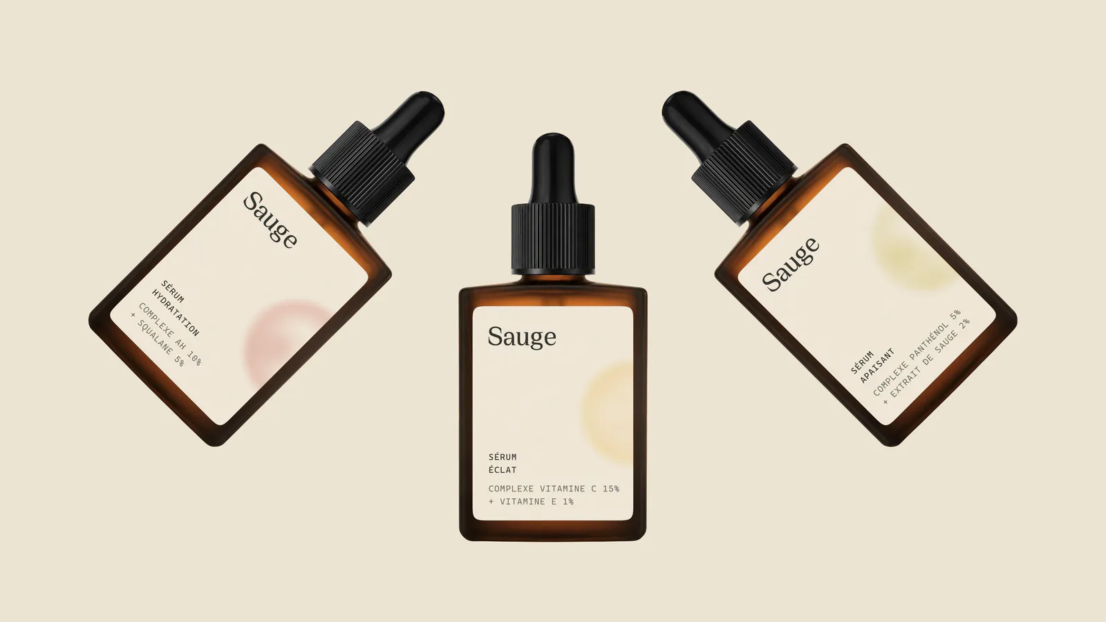 Three Sauge amber dropper bottles at angles on ivory